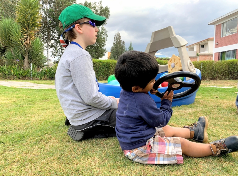 Boys sitting together on grass