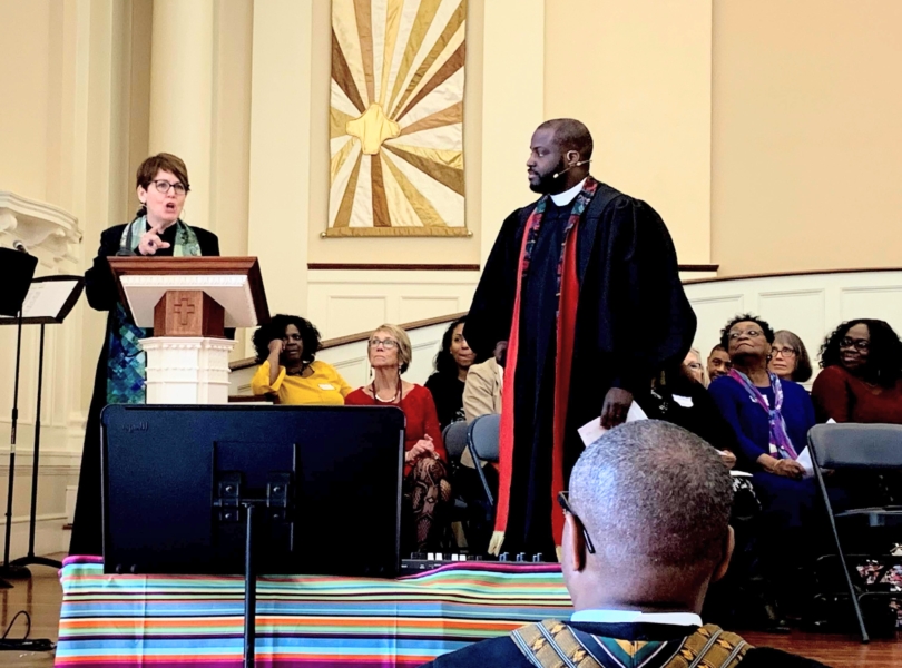 Preachers speak together at the altar