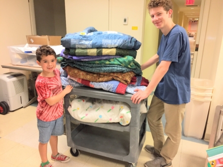 Man and child get bedding ready