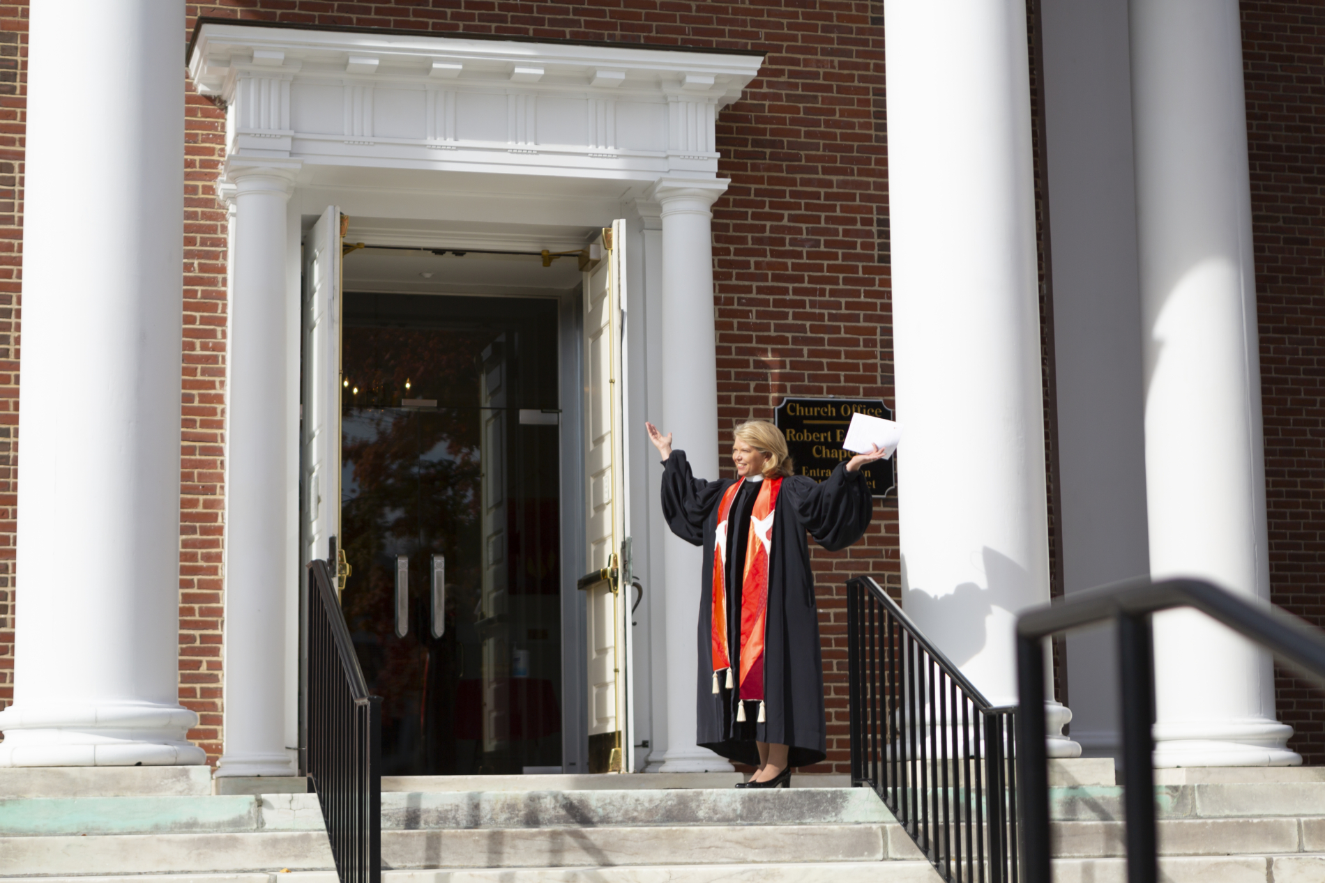 Pastor greets at church entrance