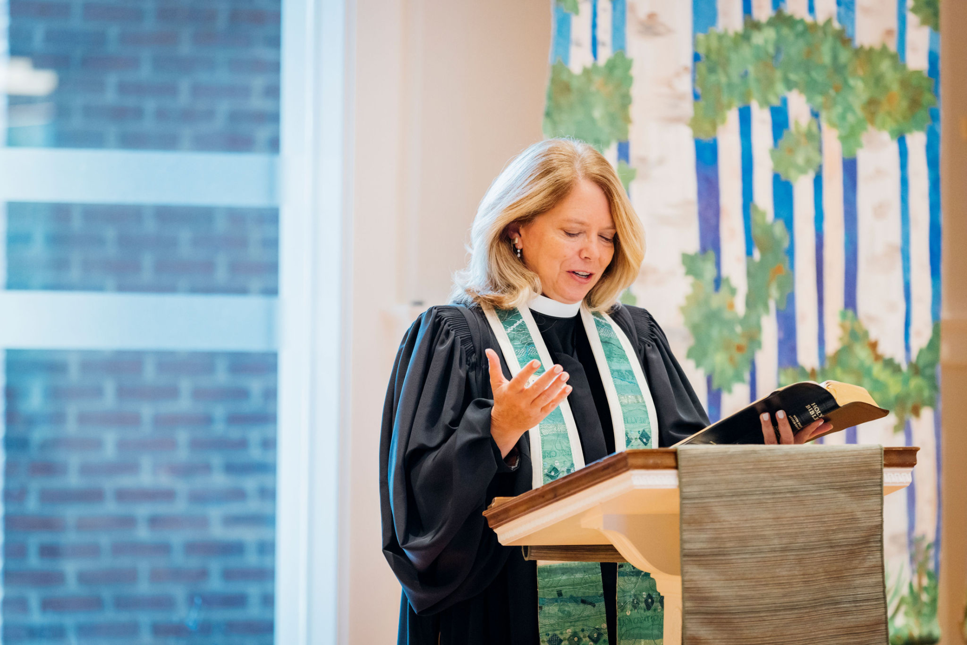 Senior pastor reads from Bible